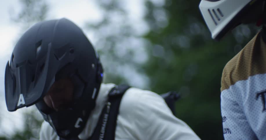 Two motorcyclists bump fists