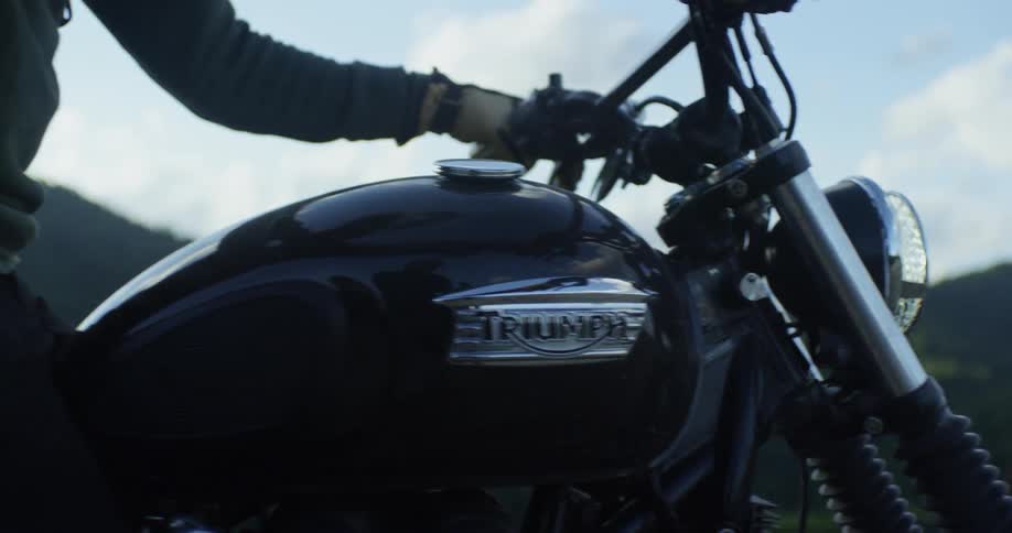 Person rides off on motorcycle on cloudy day