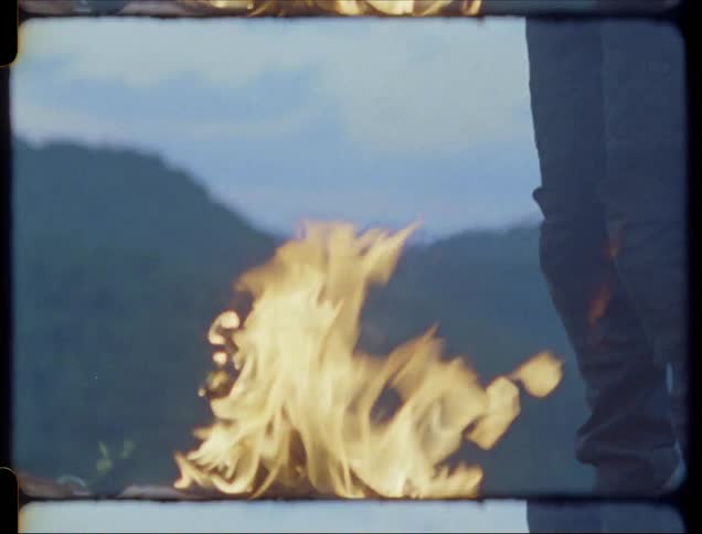 A camp fire burns outside