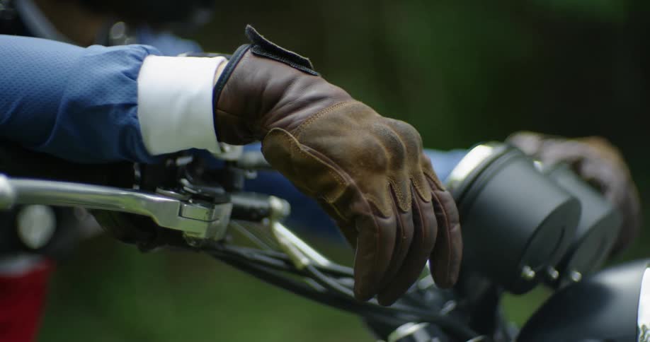Gloved hands lean on bicycle handles