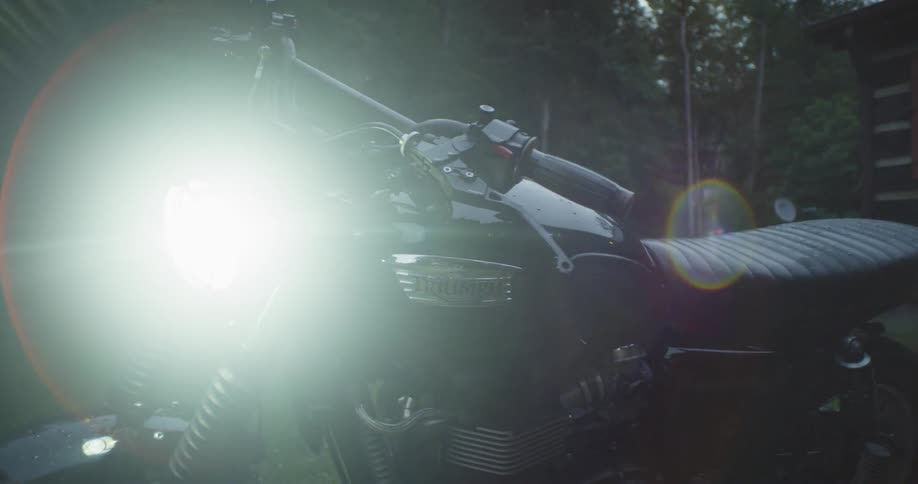 A headlight illuminates on a motorcycle