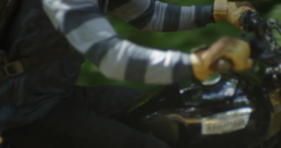 A motorcyclist rides in a forest