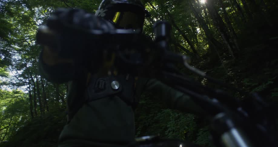A motorcyclist rides in a forest