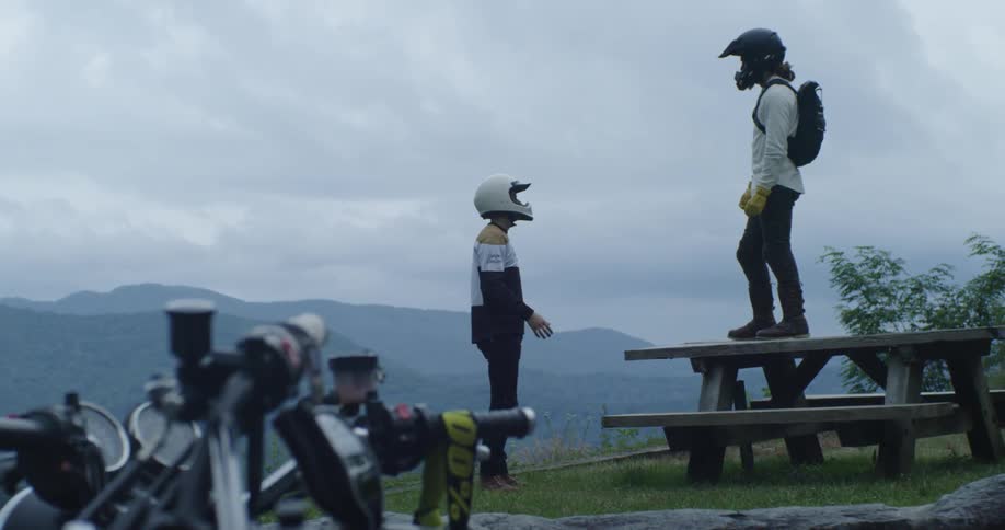 Motorcyclists stop to enjoy a mountain view