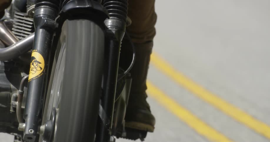 A motorcyclist rides down a road