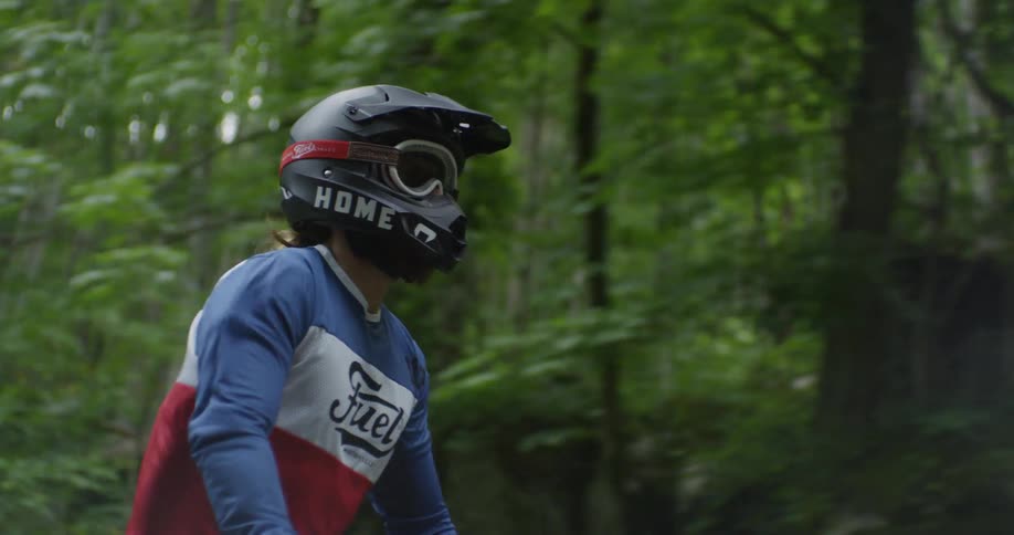 A motorcyclist rides in a forest