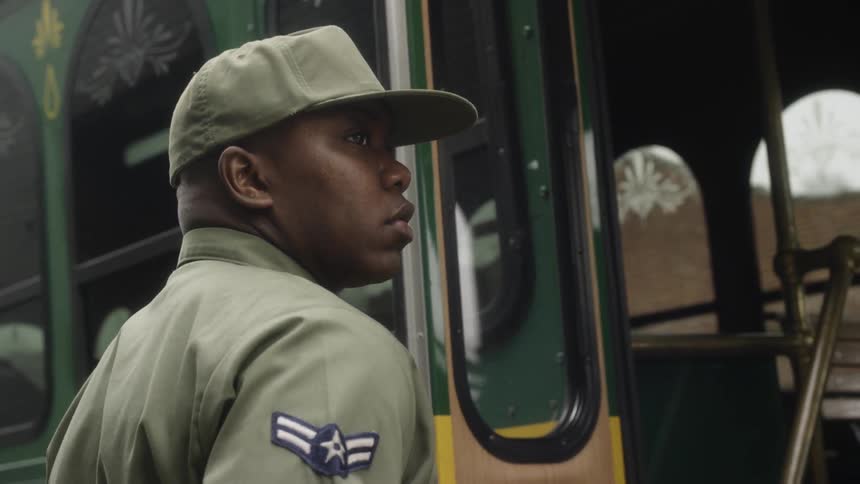 An airman boards a trolley