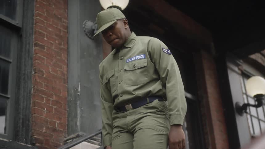 A service member walks down building steps