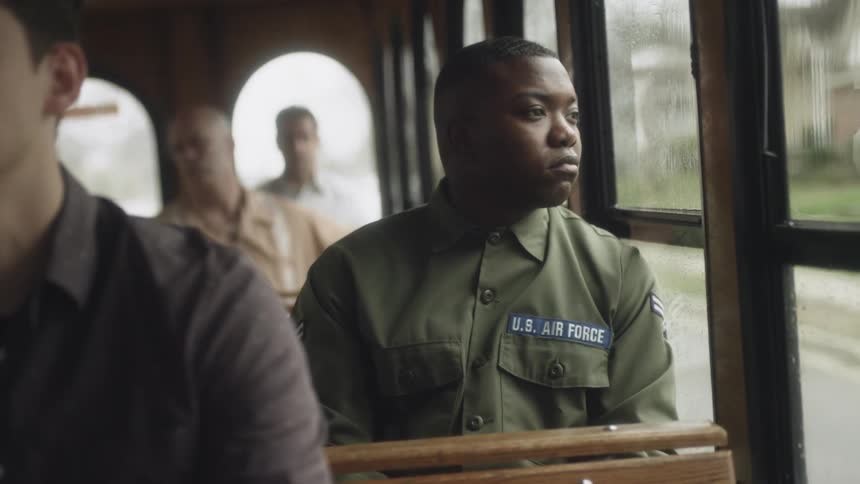 A soldier rides on the bus