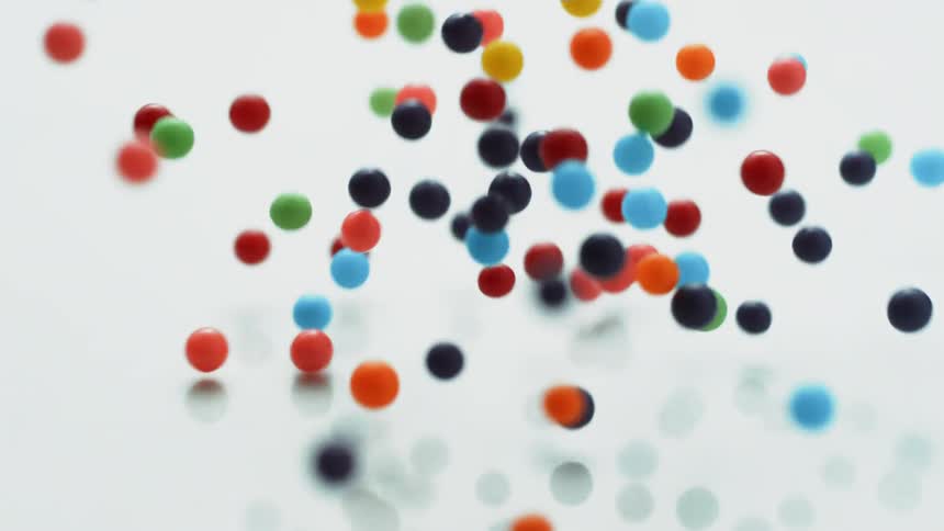 Small multicolored balls fall and bounce
