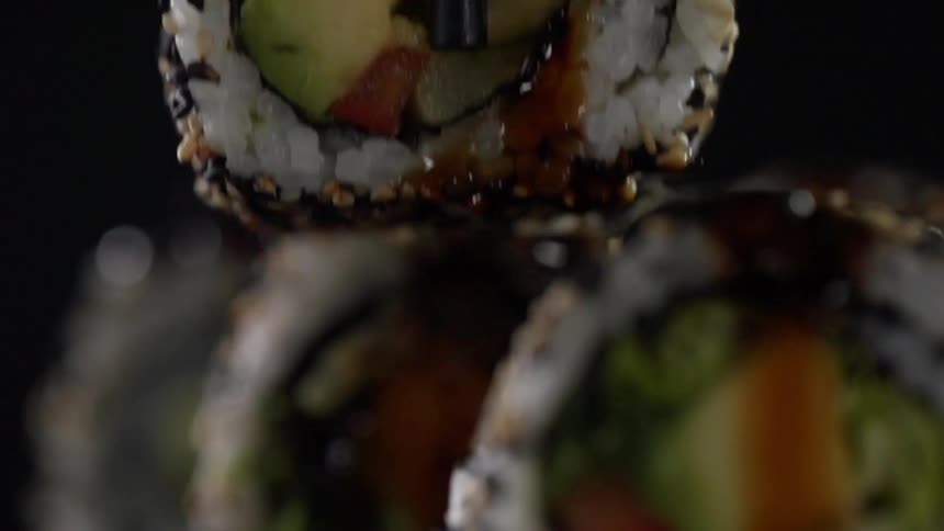Sushi is grabbed with chopsticks