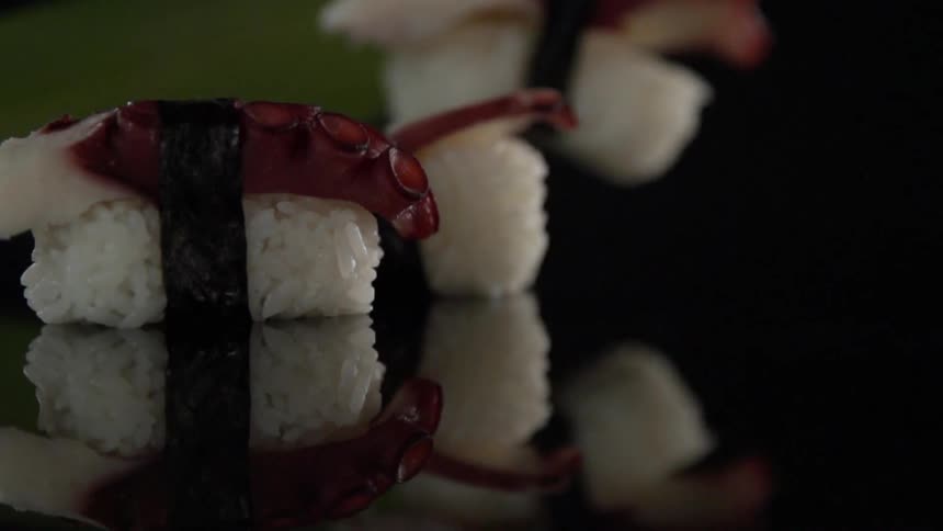 Rice with meat on top sits on a glossy surface