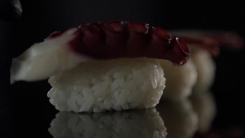 A tentacle is placed on sushi