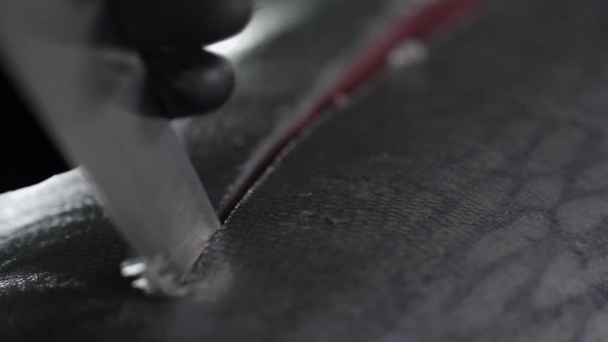 A knife cuts through a fish