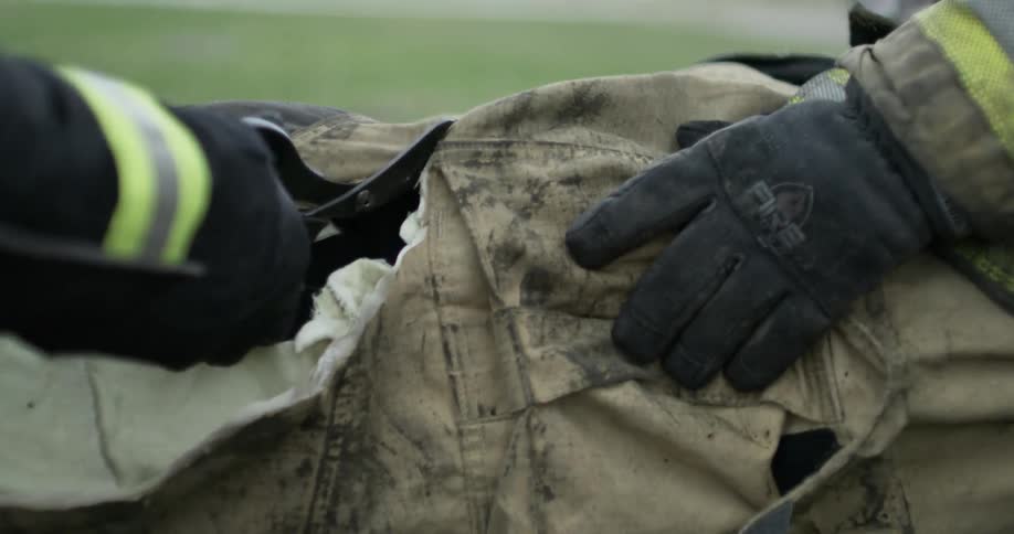 Clothes are cut from an injured fireman