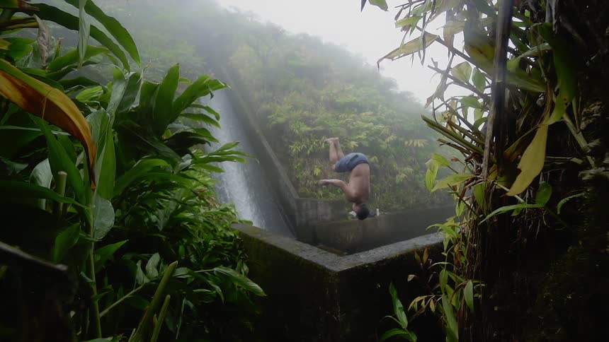 Man does a backflip into a pool of water