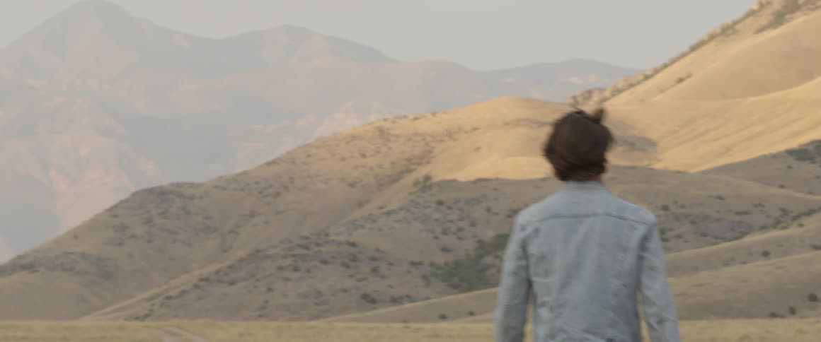 A man walks in the grass