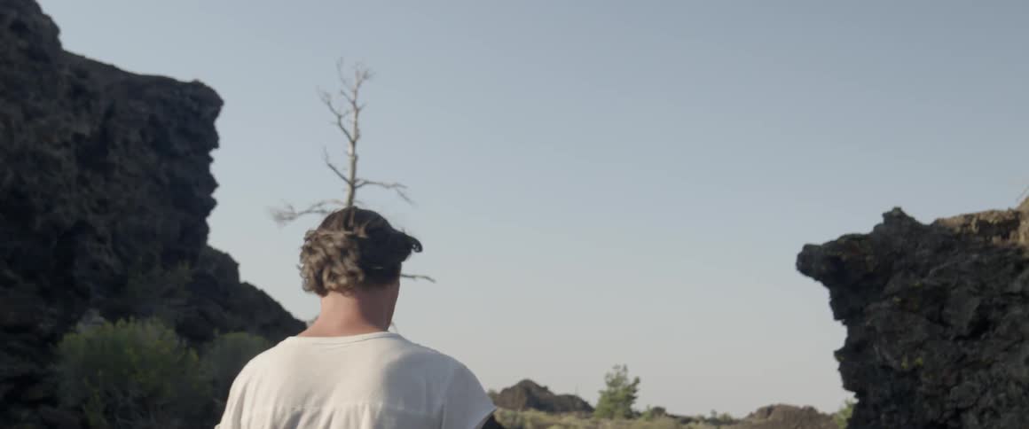 A man stands outside during the day