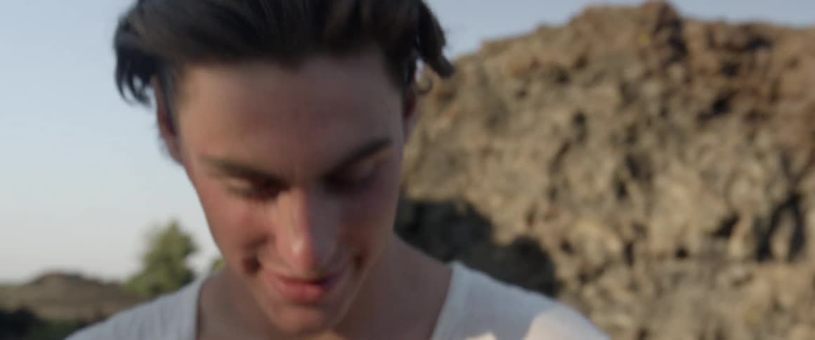 A man looks around laughing