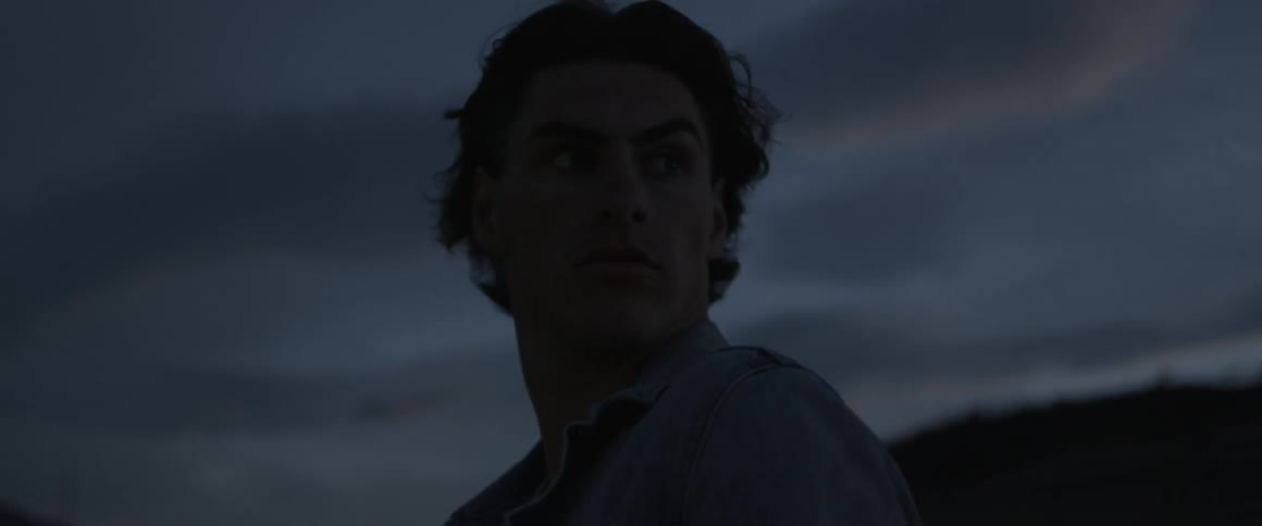 Man stands outside looking back