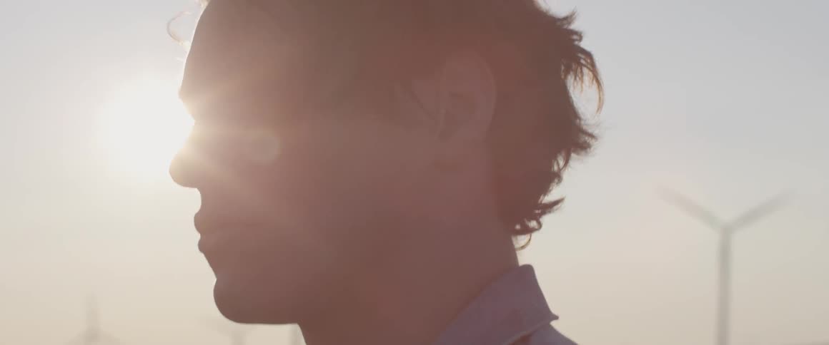 A man stands outside in the breeze