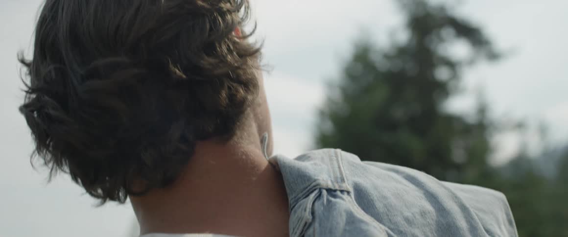 A man looks around on a cloudy day