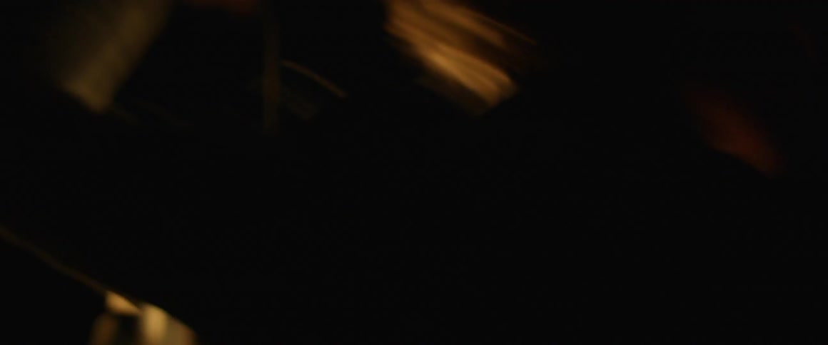 Man holds a lantern as he looks around