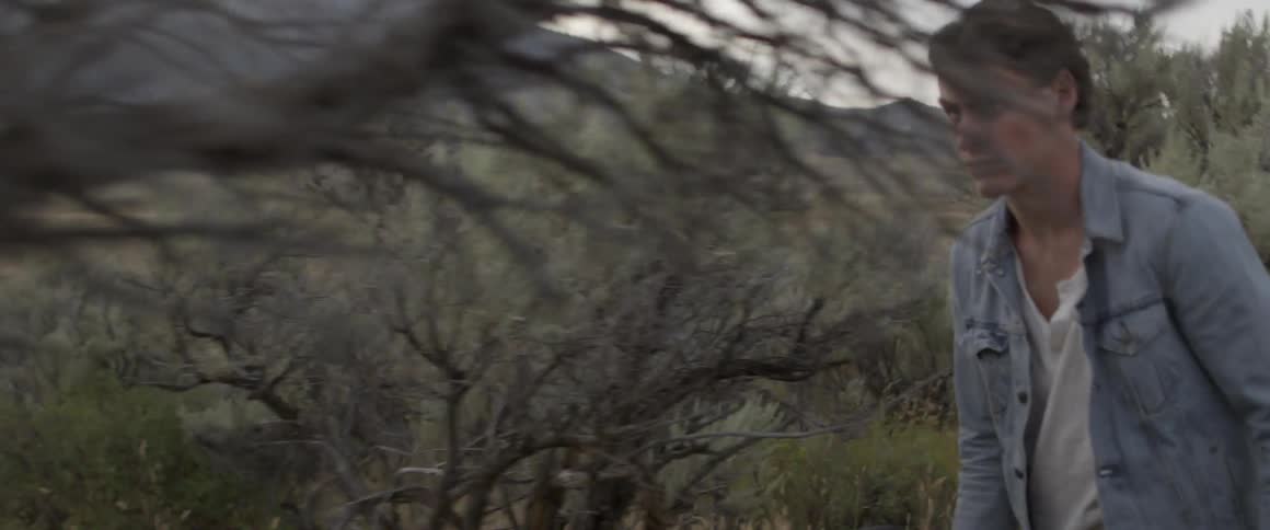 A man is walking through the field