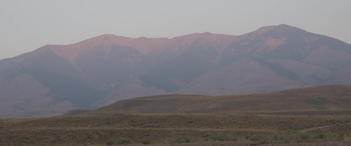 Sunlight shines on mountains at dawn