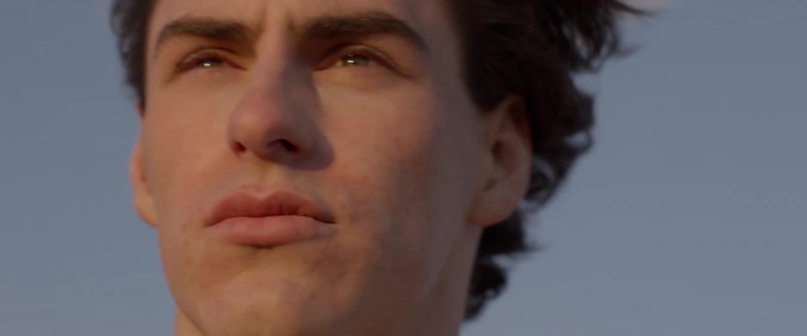Man cries while standing outside on a windy day