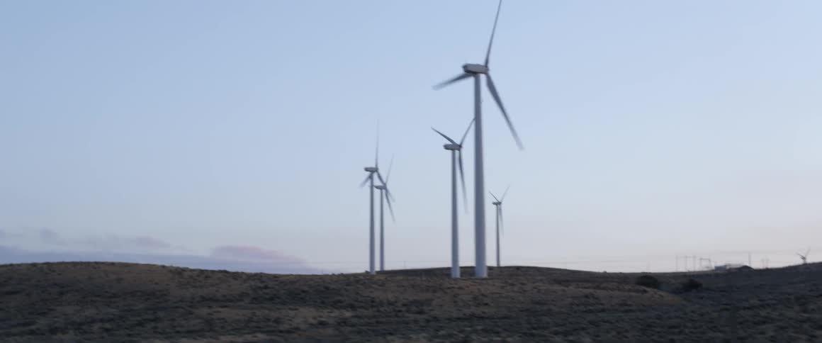Many windmills spinning in a field