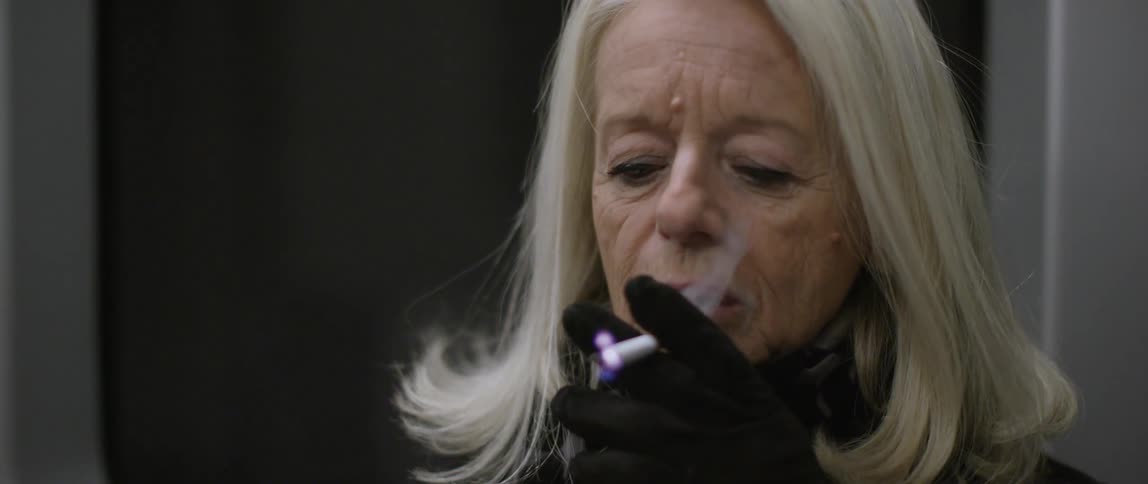 A person lighting up a cigarette