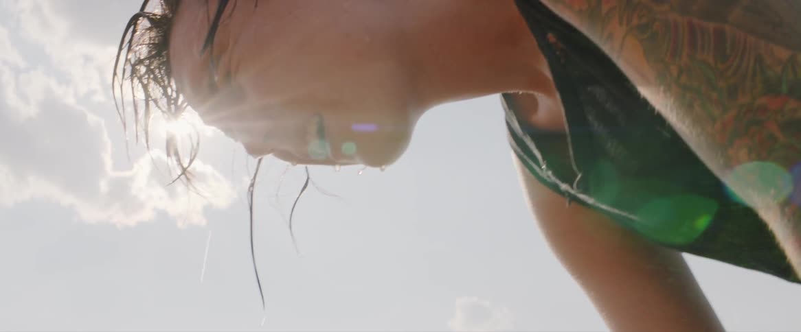 A sweating person catches their breath outside