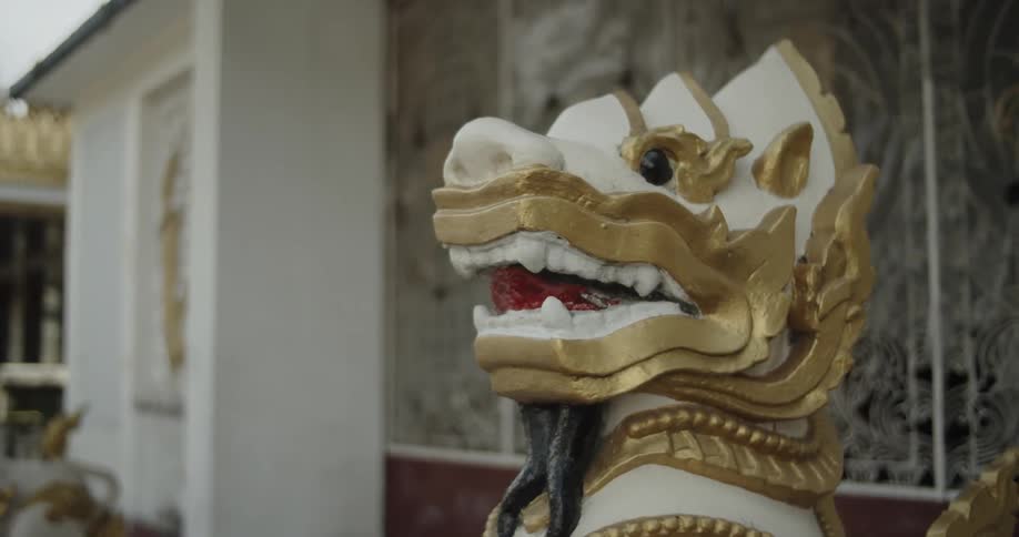 A statue of a dragon is outside the building