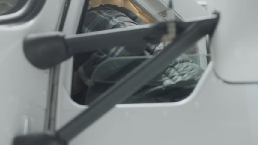 A truck driver enters the truck