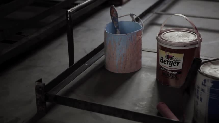Paint cans sit on a platform