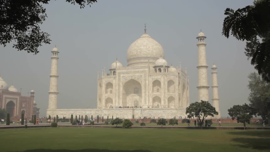 People walk near the taj mahal