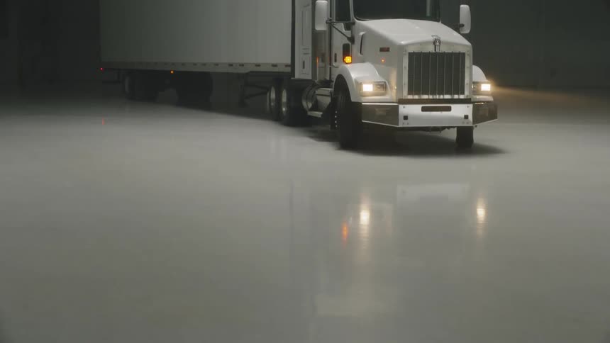 Semi truck parked in a large garage