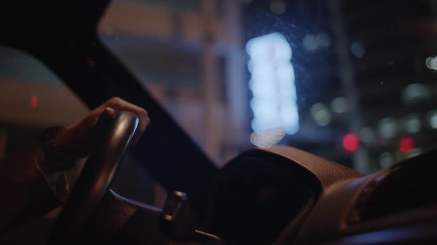 A man drives at night