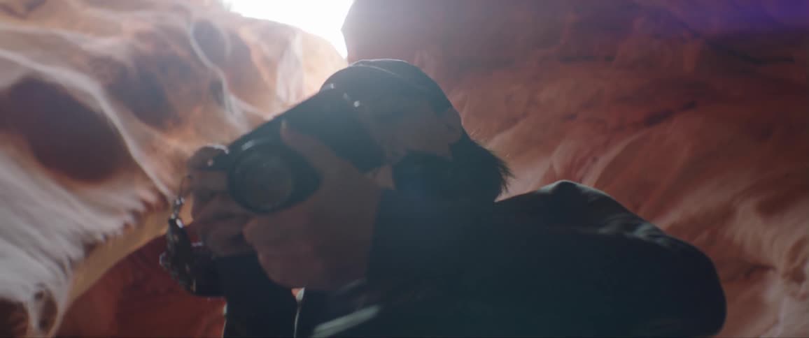A person is using a camera in the cavern
