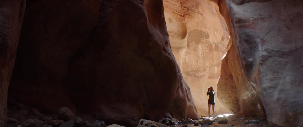 Woman Taking Photographs And Exploring Canyons