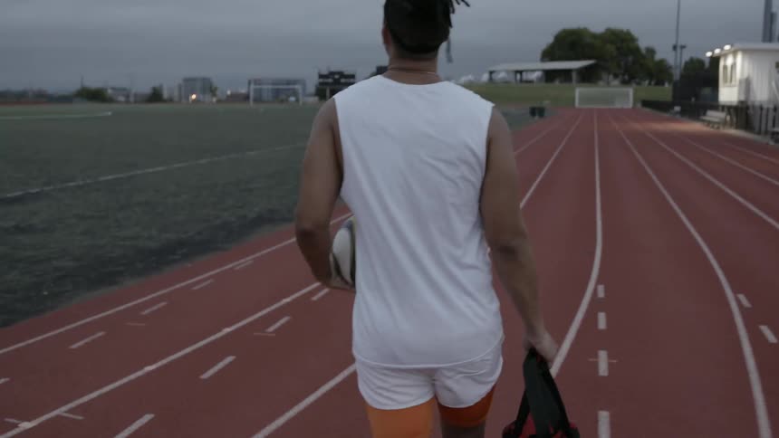 A man carries and dribbles a soccer ball
