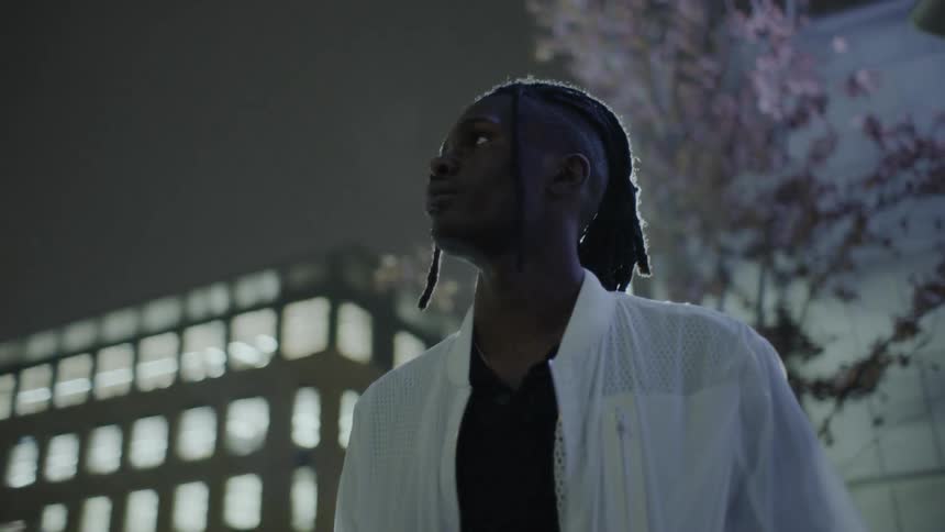 Man looks up at buildings