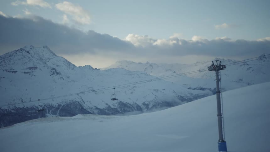 Ski lifts are carrying up and down the slope
