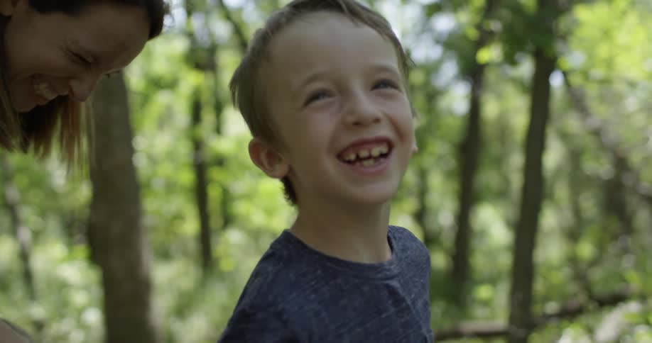 Two Boys Playing In Forest