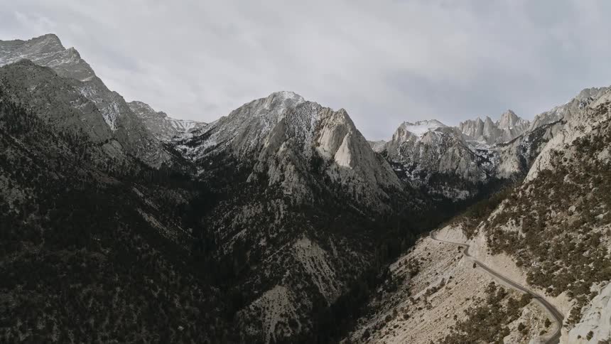 Snow covered mountains under a cloudy sky