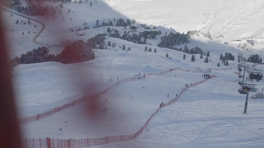 Skiers descend down the slope