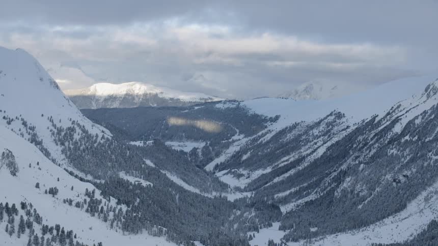 Snow covers the mountainous landscape