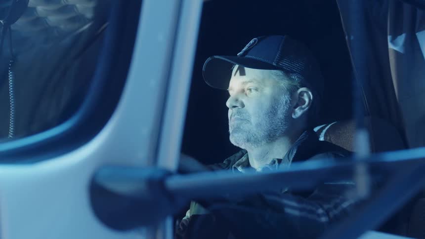 A man drives a big rig truck
