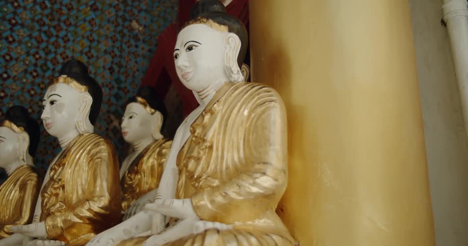 Statues of women wearing gold garments sits undisturbed